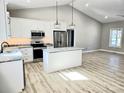 Modern kitchen with white cabinets, granite countertops, and stainless steel appliances at 107 Skyland Dr, Mount Gilead, NC 27306