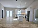 Open concept kitchen with island and stainless steel appliances at 107 Skyland Dr, Mount Gilead, NC 27306