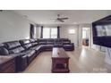 Spacious living room with sectional sofa, coffee table, and hardwood floors at 114 W Lee Ave, Bessemer City, NC 28016