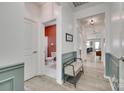 Bright hallway with a glimpse of the kitchen and a stylish bench, enhancing the home's modern appeal at 15298 Windward Ln, Lancaster, SC 29720