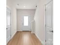 Bright entryway with light wood floors and white doors at 1530 Doran Ter, Richburg, SC 29729