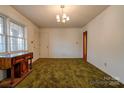 Bright living room with wood floors and a vintage cabinet at 1602 Eaves Rd, Shelby, NC 28152