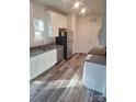 Modern kitchen featuring white cabinets, granite countertops, and stainless steel appliances at 1827 Mcdonald St, Charlotte, NC 28216
