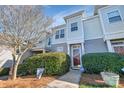 Townhome's exterior features landscaping and a red front door at 2364 Madison Green Dr, Gastonia, NC 28054