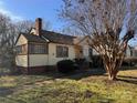 Yellow house with brown trim, a brick foundation, and a small front yard at 3101 Dogwood Ave # 3, Charlotte, NC 28206