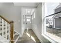 Bright entryway with hardwood floors, staircase, and large window at 4276 Black Ct # 228, Harrisburg, NC 28075