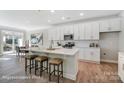 Modern kitchen featuring white cabinets, island, and stainless steel appliances at 4276 Black Ct # 228, Harrisburg, NC 28075