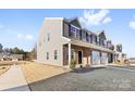 Two-story townhome with gray siding, brick accents, and a landscaped front yard at 543 San Marco Dr # 16, Gastonia, NC 28056