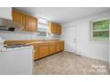 Bright kitchen with wood cabinets, white appliances, and tile floor at 61 17Th Street Nw Pl, Hickory, NC 28601