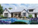 A backyard oasis features a luxurious pool, a cozy seating area with a fire pit, and lush landscaping at 6515 Rehobeth Rd # 2, Waxhaw, NC 28173