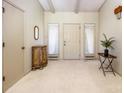 Bright entryway with new carpet, a small table, and an antique cabinet at 130 Sandy Shore Dr, Mooresville, NC 28117