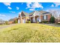 Charming brick house with a two-car garage and well-kept lawn under a sunny sky at 144 Spring Forest Dr, Shelby, NC 28152