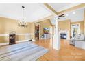 Bright open living room featuring hardwood floors, fireplace, and elegant chandelier lighting at 144 Spring Forest Dr, Shelby, NC 28152