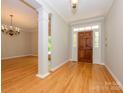 Spacious foyer showcasing hardwood floors and a traditional chandelier at 1448-1 New Prospect Church Rd, Shelby, NC 28150