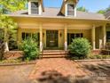 Close-up of home's welcoming front porch with brick path, offering great curb appeal at 1448-1 New Prospect Church Rd, Shelby, NC 28150