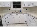 Well-lit kitchen showcasing classic white cabinets, stainless steel sink, and efficient layout at 2044 Helen Dr, Gastonia, NC 28054