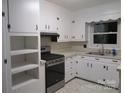 White kitchen with gas range and ample cabinet space at 2044 Helen Dr, Gastonia, NC 28054
