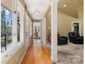 Bright hallway with hardwood floors, leading to the living areas at 3406 Red Fox Trl, Weddington, NC 28104