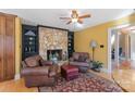Cozy sitting area with stone fireplace and comfortable leather chairs at 3406 Red Fox Trl, Weddington, NC 28104