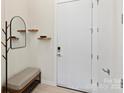 Stylish entryway with bench and coat rack at 3630 N Davidson St # 4413, Charlotte, NC 28205