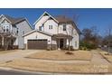 Well-maintained two-story home featuring neutral siding, stone accents, and a landscaped yard at 433 Belton St, Charlotte, NC 28209