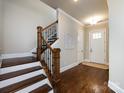 Inviting foyer with hardwood floors, staircase, and a view of the front door and entry area at 433 Belton St, Charlotte, NC 28209