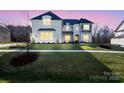Charming two-story home with manicured lawn and classic architectural details at 6124 Music Arbor Ln, Huntersville, NC 28078