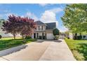Two-story house with a landscaped lawn and driveway at 8244 Fox Swamp Rd, Charlotte, NC 28215