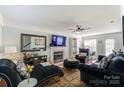 Spacious living room with fireplace and comfy seating at 8244 Fox Swamp Rd, Charlotte, NC 28215