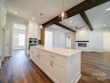 White kitchen island with quartz countertops and hardwood floors at 0000 Trull Hinson Rd, Wingate, NC 28174