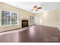 Living room featuring hardwood floors and a fireplace at 11006 Renoir Ct, Charlotte, NC 28215