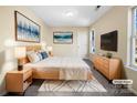 Virtually staged main bedroom with large bed and dresser at 11006 Renoir Ct, Charlotte, NC 28215