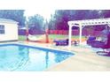 Relaxing pool area with pergola, hammock, and patio furniture at 1250 Wendover Ave, Albemarle, NC 28001