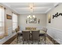 Elegant dining room with coffered ceiling, chandelier, and sophisticated decor at 136 Margo Ln, Statesville, NC 28677