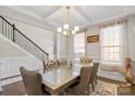 Refined dining room with coffered ceilings, designer lighting, and hardwood floors at 136 Margo Ln, Statesville, NC 28677