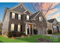 Attractive brick home with a manicured front lawn, and colorful sunset backdrop at 136 Margo Ln, Statesville, NC 28677
