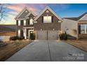 Brick two-story house with two-car garage, landscaping, and a well-manicured lawn at 136 Margo Ln, Statesville, NC 28677