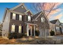 Two-story brick home featuring manicured landscaping and a welcoming front entrance at 136 Margo Ln, Statesville, NC 28677