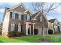 Charming two-story brick home with well-maintained lawn and landscaping at 136 Margo Ln, Statesville, NC 28677