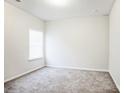 Empty carpeted bedroom with window and neutral walls at 1415 Troon Dr, Salisbury, NC 28144