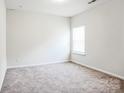 Simple carpeted bedroom with a window and neutral walls at 1415 Troon Dr, Salisbury, NC 28144