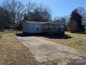 Mobile home with a long driveway and mature trees at 181 Jeter St, Chester, SC 29706