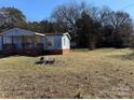Blue mobile home with a large yard and storage shed at 181 Jeter St, Chester, SC 29706