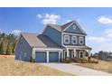 Beautiful blue two-story home with a two-car garage and stone accents at 24078 Sailfish Dr # 1152, Lancaster, SC 29720