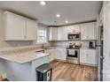 Modern kitchen with white cabinets, granite countertops, and stainless steel appliances at 257 Mighty Joe Trl, York, SC 29745