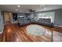 Spacious living area with hardwood floors, ample seating, and neutral decor at 327 Johnson Dairy Rd, Mooresville, NC 28115