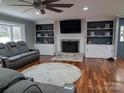 Bright living room with built-in shelving around fireplace and large window with natural light at 327 Johnson Dairy Rd, Mooresville, NC 28115