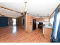 Kitchen with light wood cabinets, black appliances, and laminate floors at 3463 Rock Creek Dr, Newton, NC 28658