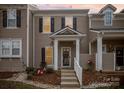 Two-story townhome with light brown siding, white trim, and landscaping at 6330 Rhodins Ln, Indian Land, SC 29707