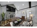 Virtually staged living room with fireplace and hardwood floors at 709 Grass Dr, Charlotte, NC 28216